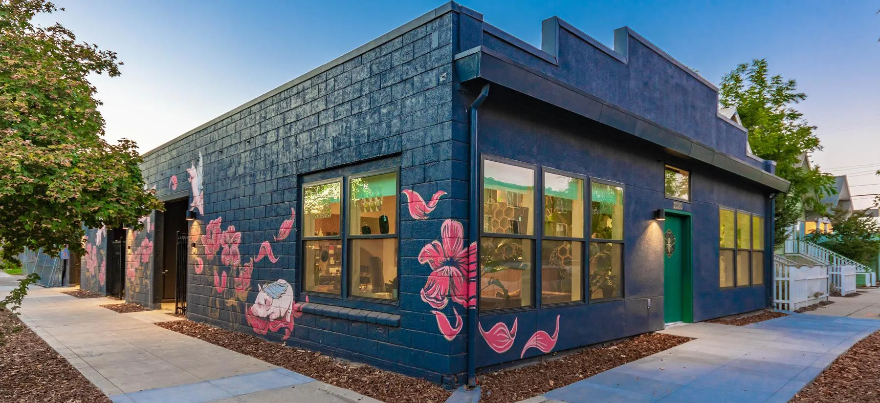 Renovated commercial building at 2030 28th Street Sacramento with dark blue exterior and floral murals