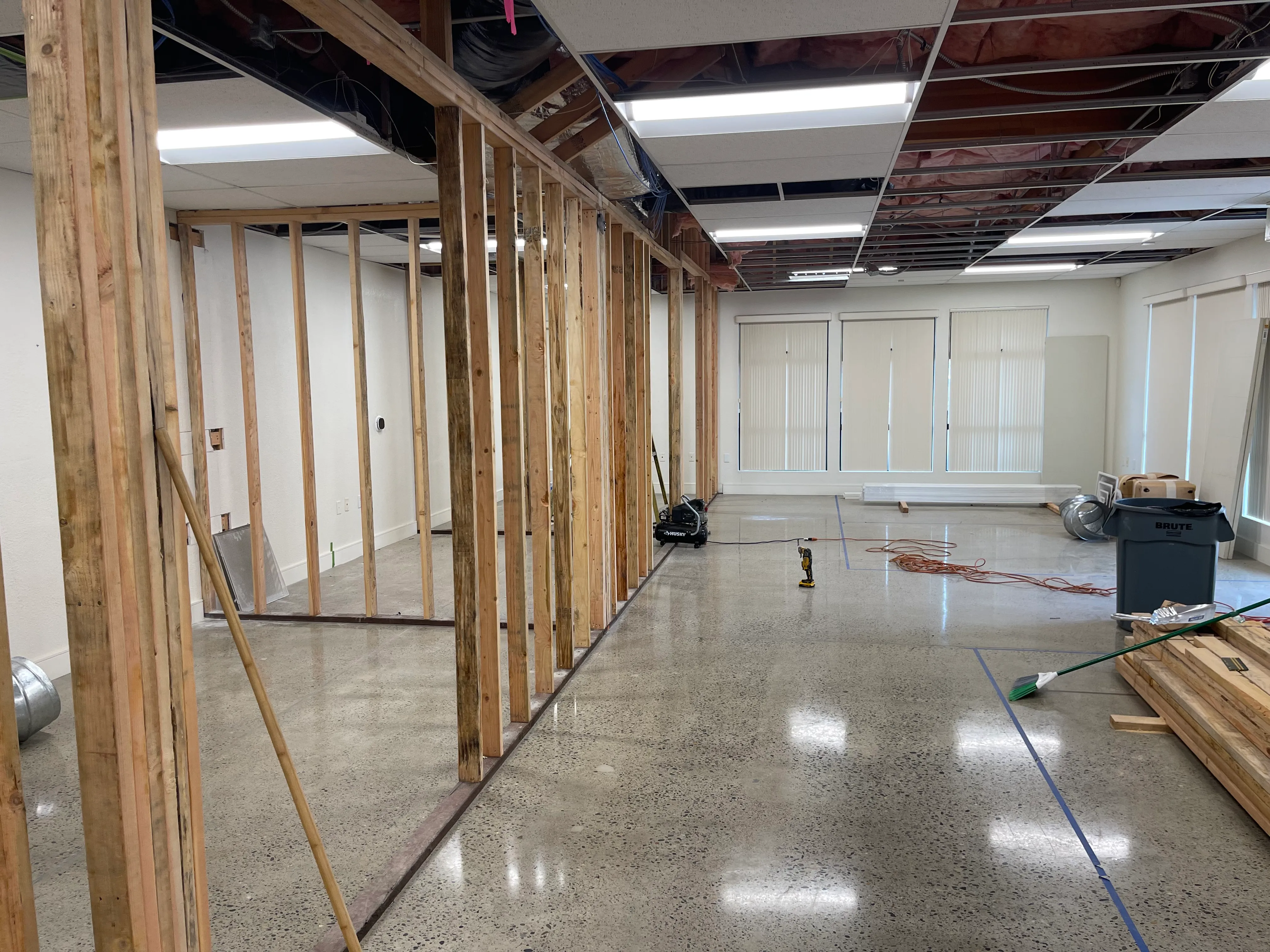 Interior framing and polished concrete floors during 3001 E Street office renovation with exposed ceiling and new wall studs