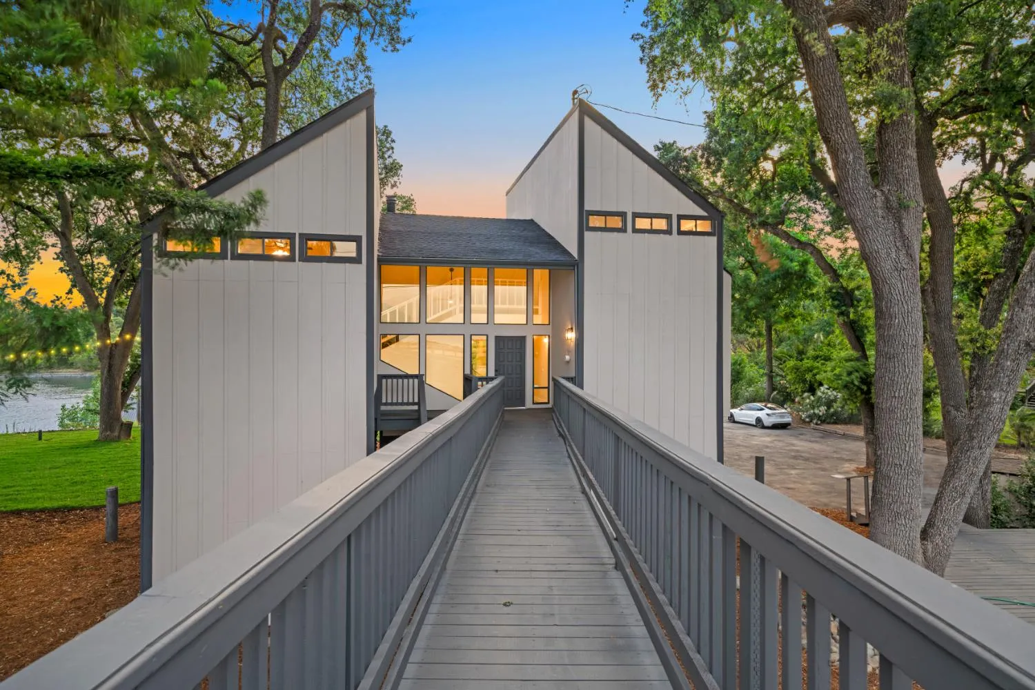 Refinished entry footbridge at 3777 Garden Highway leading to the glass-walled entry between twin gable wings