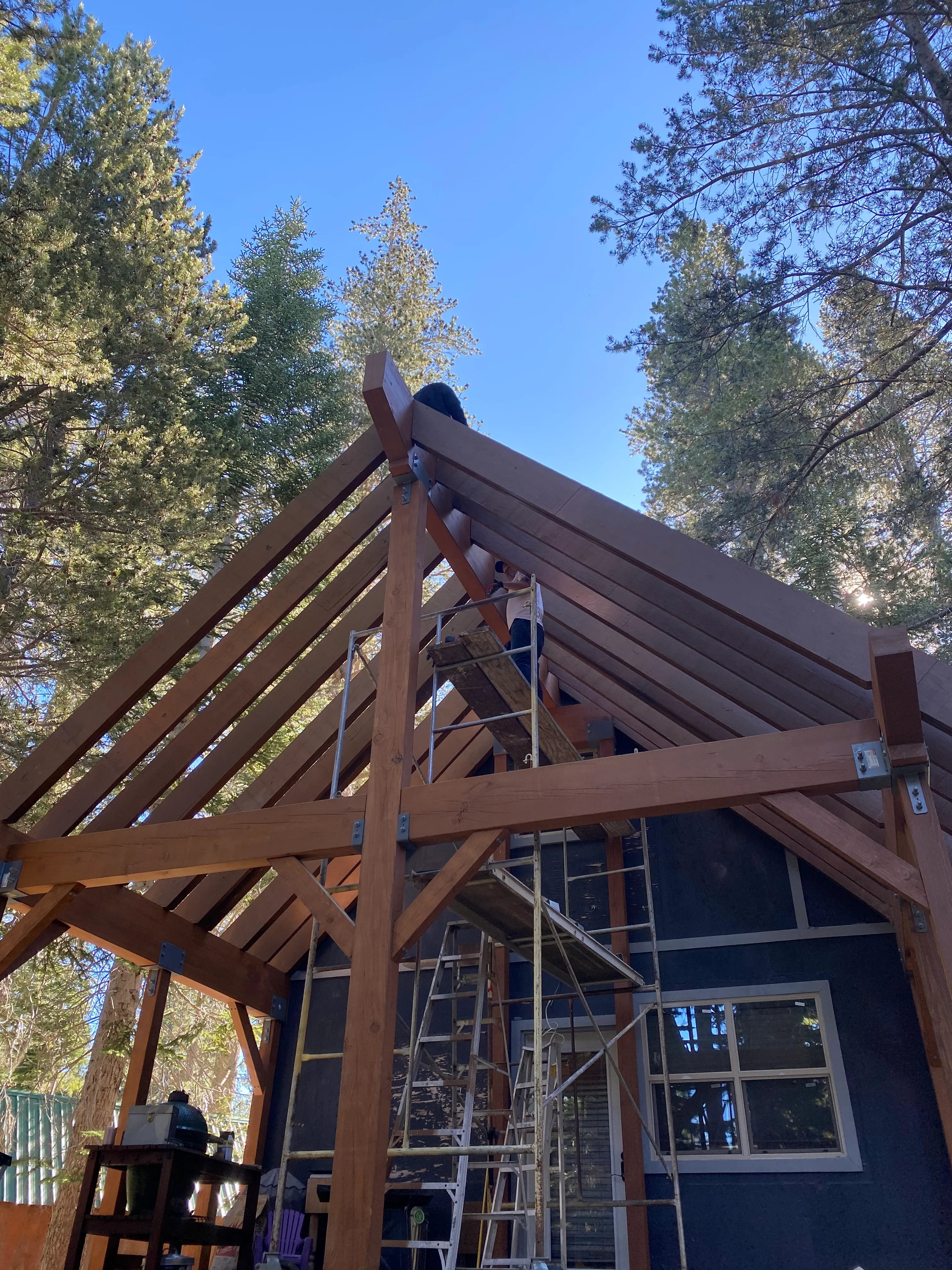 Timber deck framing and cross-bracing on the upper level of the cabin addition