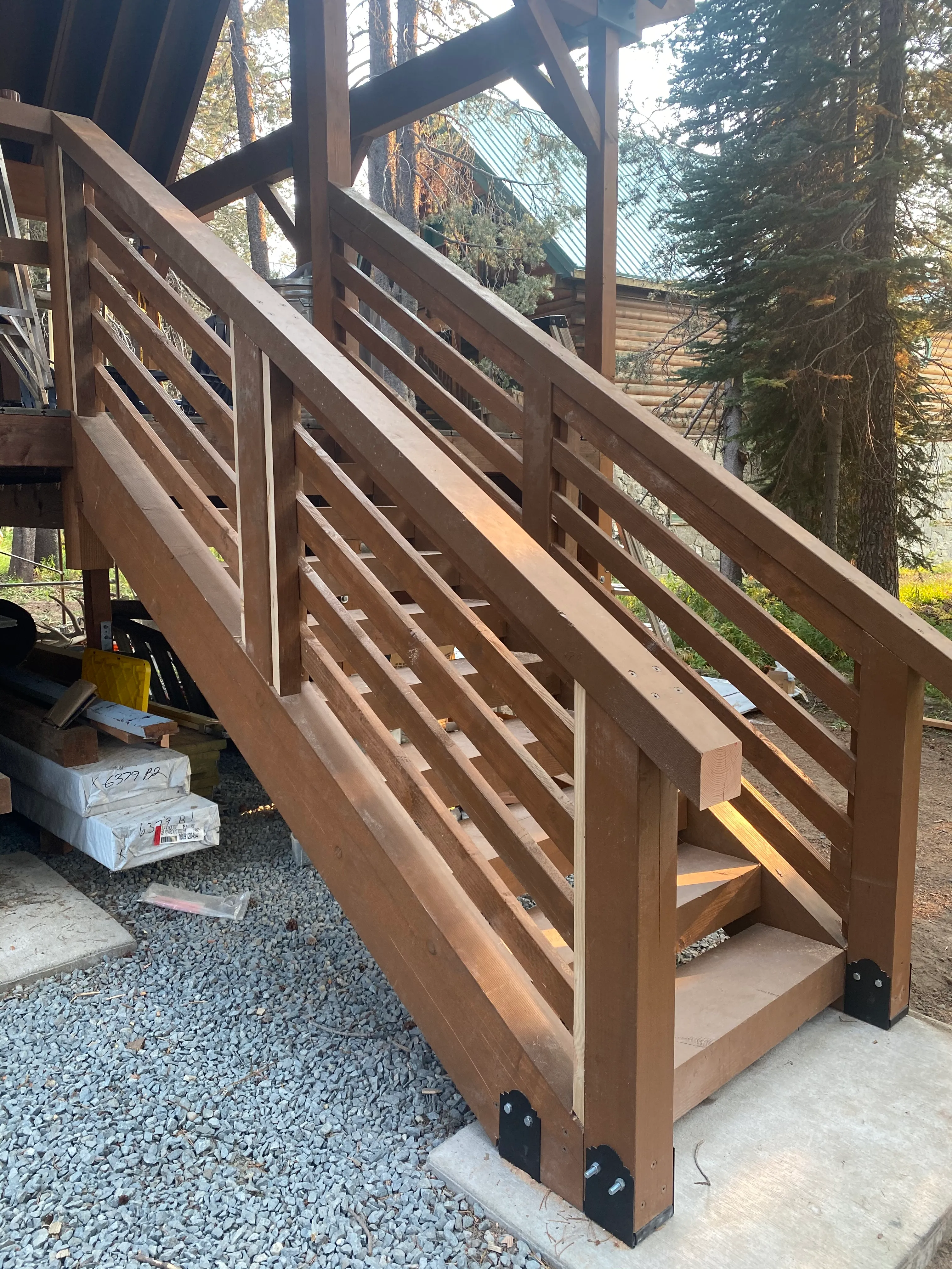 Wood stair and railing framing under construction at the cabin deck
